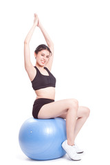 Fototapeta premium Young woman doing exercises with fitness ball.