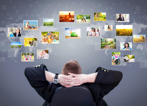 Businessman siting and looking at photo gallery images