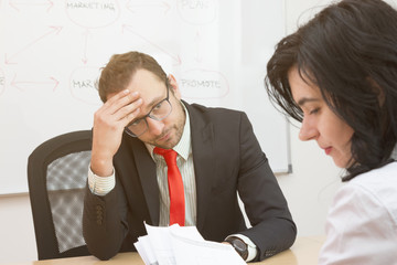 Unsatisfied boss and sad female worker 