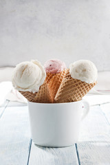 Three ice cream cones are in the cup.