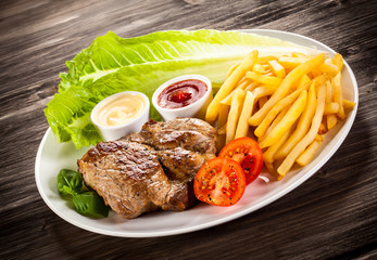 Grilled steak, French fries and vegetables 