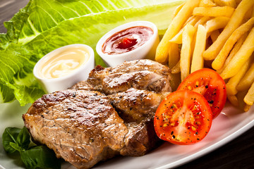 Grilled steak, French fries and vegetables 