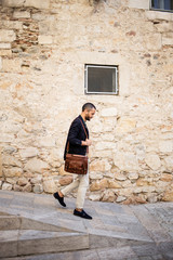 Bearded stylish man walking down the street