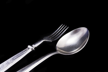 Spoon and fork on a black velvet