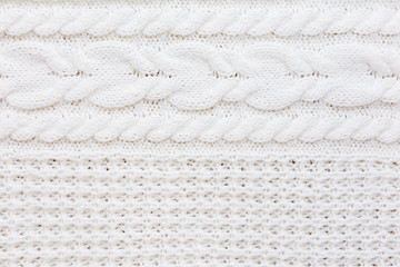 Abstract knitted background. Wool white sweater texture. Close up picture of  knitted pattern.