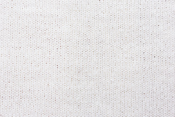 Abstract knitted background. Wool white sweater texture. Close up picture of  knitted pattern.