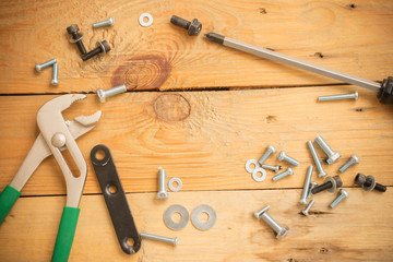 wrench tool on wooden vintage background.