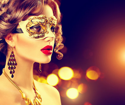 Beauty model woman wearing venetian masquerade carnival mask at party