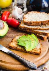 toast with fresh avocado and pepper, healthy snack, vegetarian f