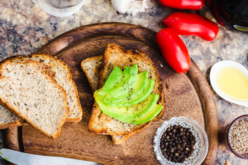 toast with fresh avocado and pepper, healthy snack, vegetarian f