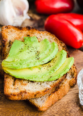 toast with fresh avocado and pepper, healthy snack, closeup