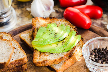 toast with fresh avocado and pepper, healthy snack, closeup
