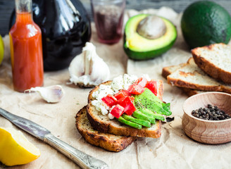 toast with fresh avocado, tomato and goat cheese, vegetarian sna