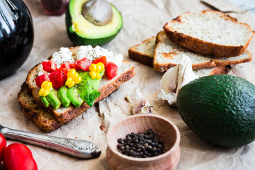 toast with fresh avocado, tomato and corn, a cup of coffee, brea