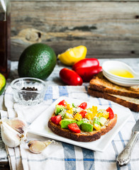 toast with fresh avocado, tomato and corn