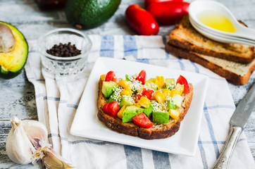 toast with fresh avocado, tomato and corn