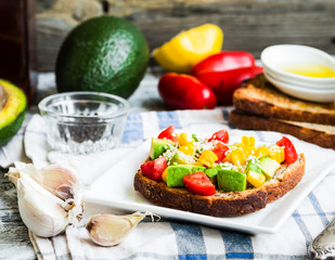 toast with fresh avocado, tomato and corn
