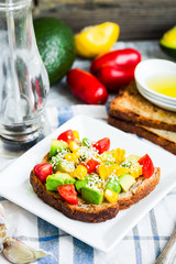 toast with fresh avocado, tomato and corn