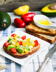 toast with fresh avocado, tomato and corn