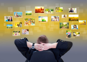 Businessman siting and looking at photo gallery images