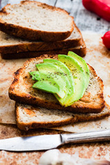 toast with fresh avocado and pepper, healthy snack, vegetarian f