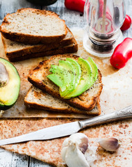 toast with fresh avocado and pepper, healthy snack, vegetarian f
