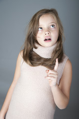 Portrait of a little girl looking at the top..