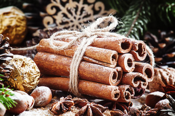Bunch of cinnamon sticks in a Christmas composition with walnuts