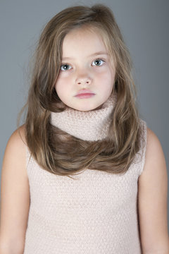 Portrait of a little girl with long hair..