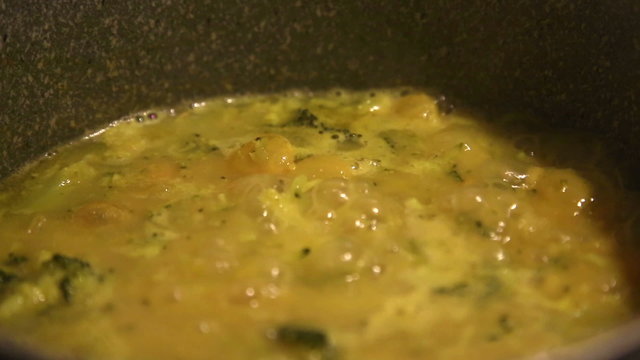 making of broccoli soup, beans and onions, on the stove