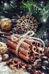 Bunch of cinnamon sticks in a Christmas composition with walnuts