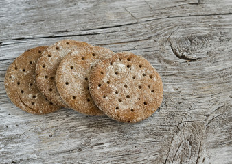 Rye flatbread on rustic light wooden surface. Healthy food
