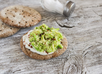 Healthy avocado sandwiches,  on a dark wooden surface. Healthy breakfast or snack