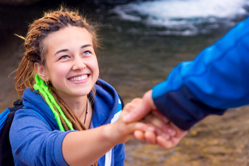 Two Hikers young Man and Smiling Woman holding hands