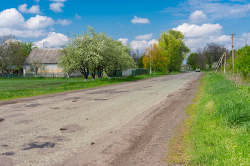 Fototapeta na wymiar Spring landscape with old road through Dmukhailivka village, Dnepropetrovskaya oblast, Ukraine