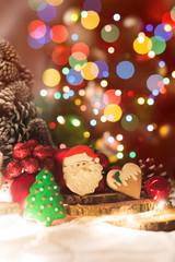 Fototapeta na wymiar Christmas decoration. Cookie in a shape of a Santa Claus, pinecone, Christmas tree, heart... Shallow depth of field.