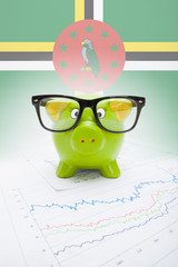 Piggy bank with flag on background - Dominica