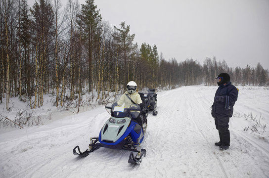 Woman driving snowmobile in Ruka in Lapland