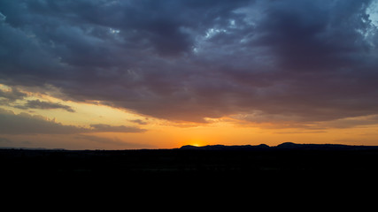 Back lit silhouettes on an orange sunset cloudscape