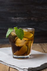 Cuba libre with lime on black wooden table