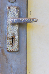 A rusted metal  a wooden gate