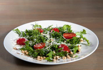 Salad cherry tomatoes with arugula and Parmesan.selective focus