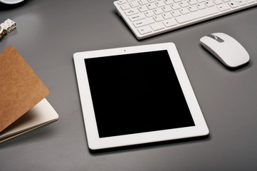 White tablet computer on a gray surface