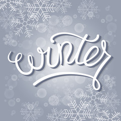 Winter Card Vector Illustration. Hand Lettered Text with Snow Symbols on a Blue Background.