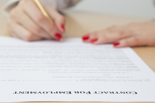 Woman signing employment contract 
