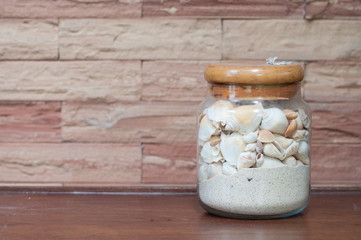 Jar with sand and shell