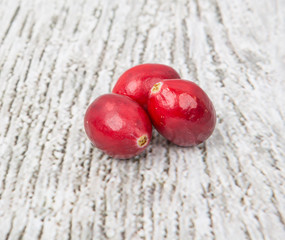 Cranberries fruit over wooden background