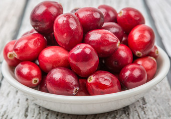 Cranberries fruit over wooden background