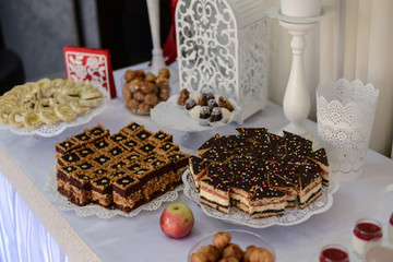 Delicious sweet buffet with cupcakes, tiramisu glasses and other