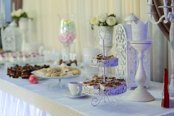 Delicious sweet buffet with cupcakes, tiramisu glasses and other